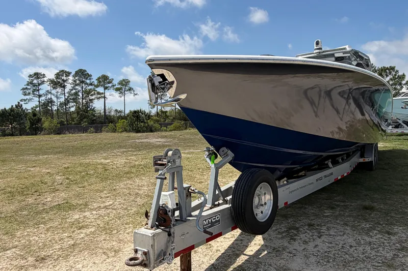 Slide: The Image of 2018 Nor-Tech 452 Super Fish boat on trailer in grassy area under blue sky. - 4