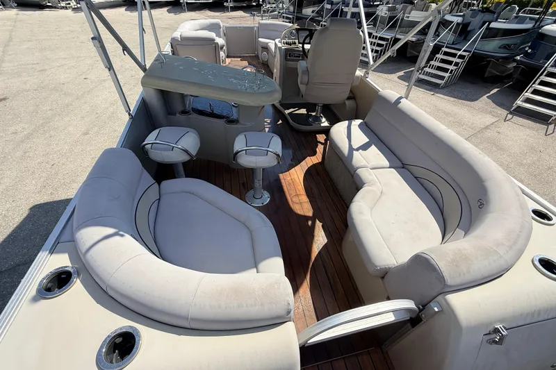 Slide: The Image of 2014 Avalon 2485 Catalina Entertainer boat interior with plush seating and bar area. - 13