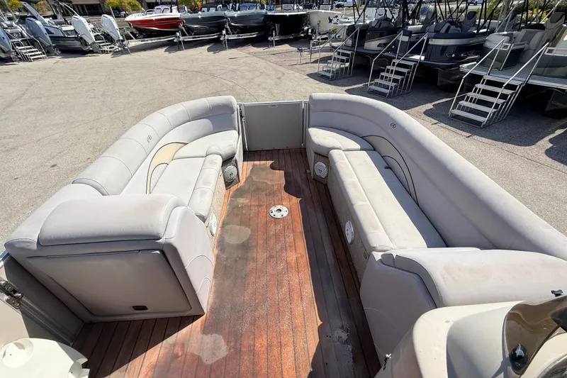 Slide: The Image of 2014 Avalon 2485 Catalina Entertainer boat with spacious seating and wooden deck. - 14