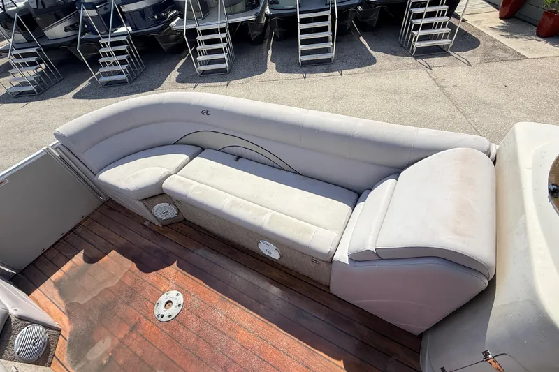 Slide: The Image of 2014 Avalon 2485 Catalina Entertainer boat with spacious seating and wooden deck. - 16