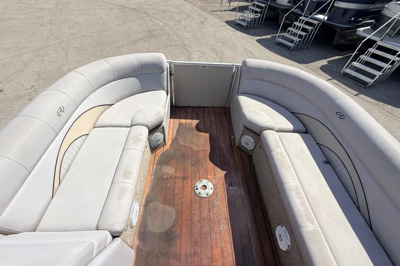 Slide: The Image of 2014 Avalon 2485 Catalina Entertainer boat interior with plush seating and wooden deck. - 17
