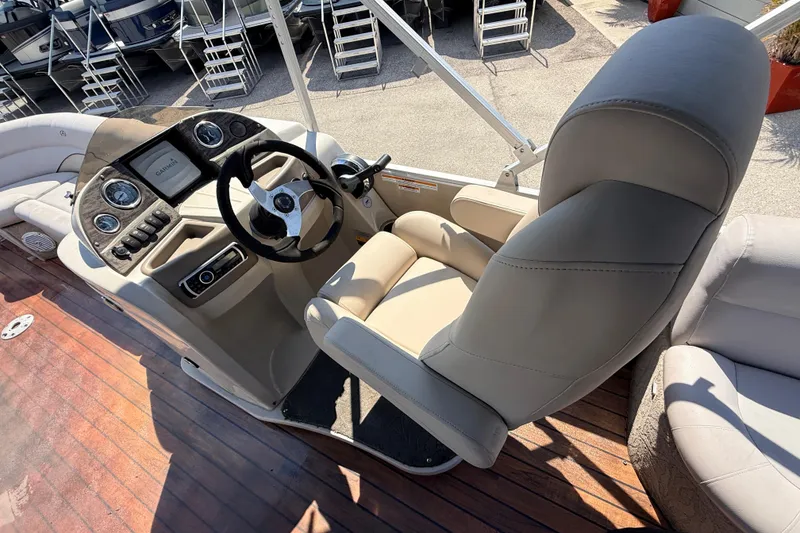 Slide: The Image of Captain's chair and dashboard of 2014 Avalon 2485 Catalina Entertainer boat. - 26