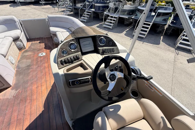 Slide: The Image of 2014 Avalon 2485 Catalina Entertainer boat interior with steering console and seating. - 27