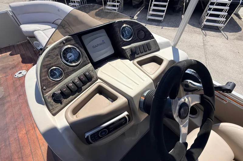 Slide: The Image of 2014 Avalon 2485 Catalina boat dashboard with Garmin display and steering wheel. - 29