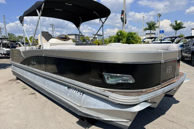 Slide: The Image of 2014 Avalon 2485 Catalina Entertainer Tri Toon boat with canopy, parked outdoors. - 5