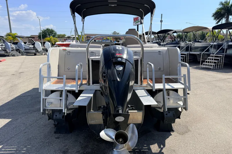 Slide: The Image of 2014 Avalon 2485 Catalina Entertainer pontoon boat with outboard motor, parked outdoors. - 8