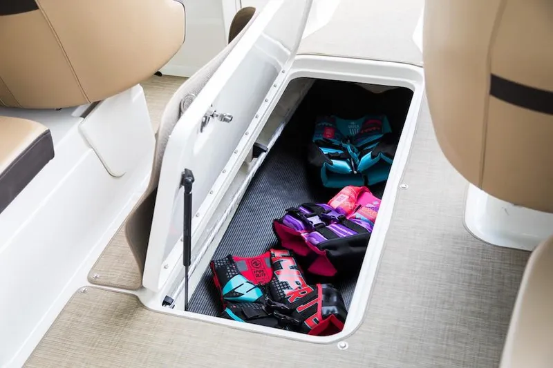 Slide: The Image of Manufacturer Provided Image: 2020 Sea Ray SPX 210 storage compartment with life jackets. - 12