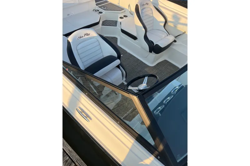 Slide: The Image of 2020 Sea Ray SPX 210 boat interior with steering wheel and seating. - 15