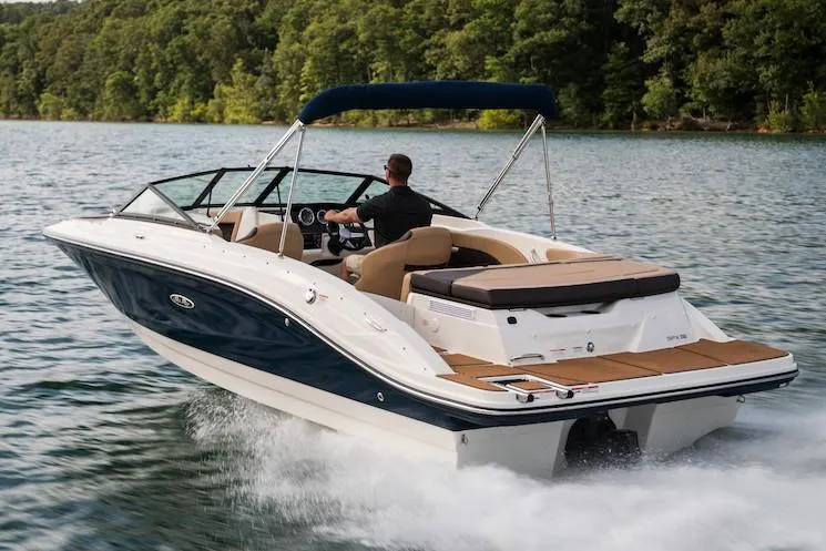 Slide: The Image of Manufacturer Provided Image: 2020 Sea Ray SPX 210 boat cruising on a lake with lush green trees in the background. - 2