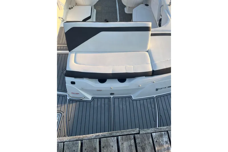 Slide: The Image of 2020 Sea Ray SPX 210 boat interior with cushioned seating and sleek flooring design. - 21