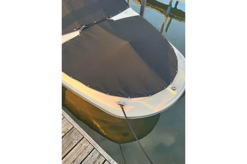 Slide: The Image of Covered 2020 Sea Ray SPX 210 boat docked on calm water. - 24