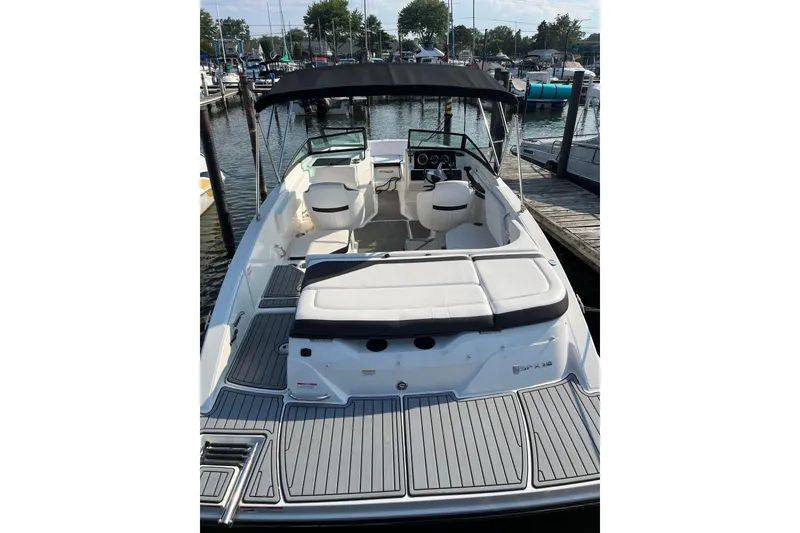 Slide: The Image of 2020 Sea Ray SPX 210 boat docked at marina, featuring spacious seating and sleek design. - 25