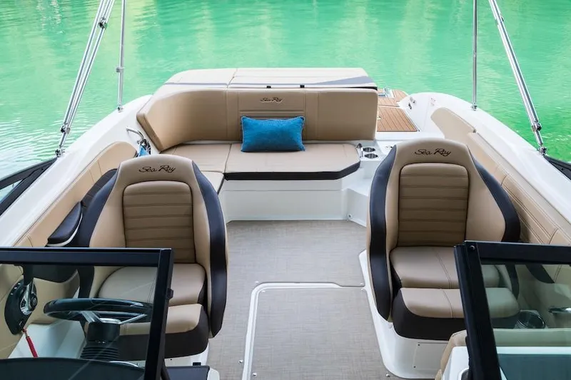 Slide: The Image of Manufacturer Provided Image: 2020 Sea Ray SPX 210 boat interior with tan seating and blue cushion. - 8