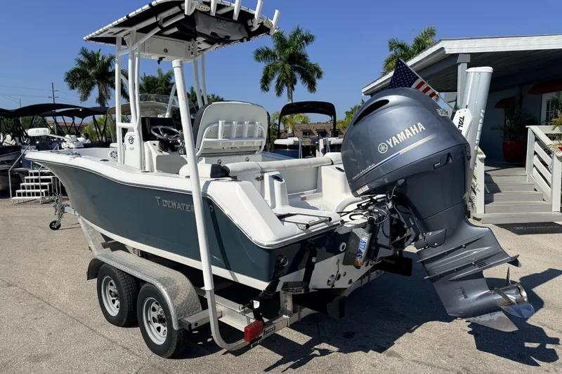 Slide: The Image of 2021 Tidewater 210 LXF boat with Yamaha engine on trailer, parked outdoors. - 11