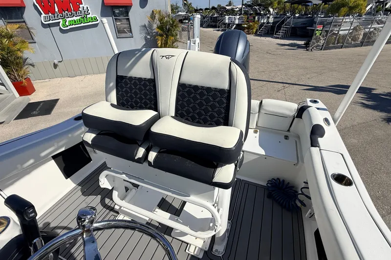 Slide: The Image of 2021 Tidewater 210 LXF boat interior with dual seats and steering wheel. - 16