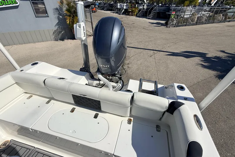 Slide: The Image of 2021 Tidewater 210 LXF boat with 150 HP engine, docked outdoors. - 17