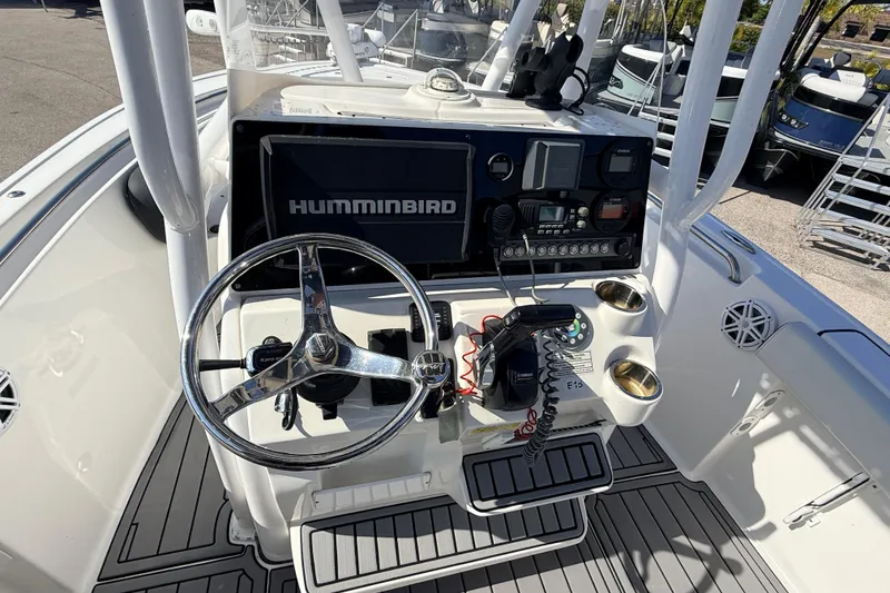 Slide: The Image of 2021 Tidewater 210 LXF boat console with steering wheel and Humminbird electronics. - 19