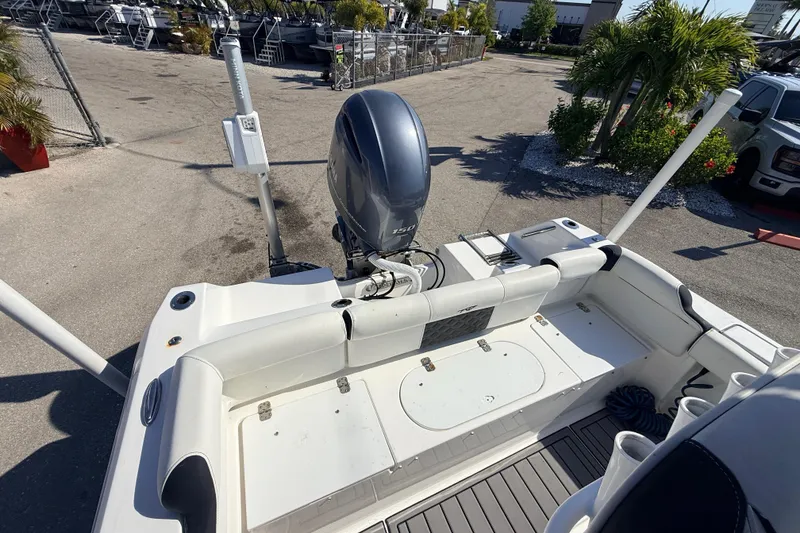Slide: The Image of 2021 Tidewater 210 LXF boat with Yamaha outboard motor in a marina setting. - 23