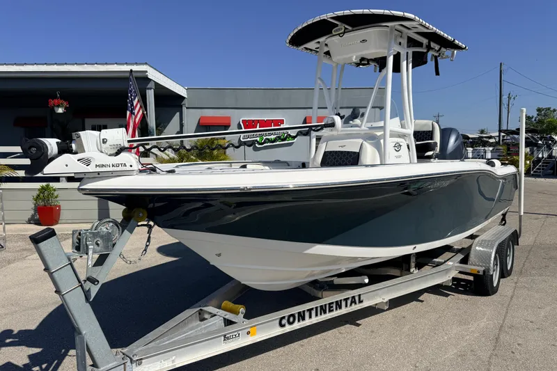 Slide: The Image of 2021 Tidewater 210 LXF boat on trailer, displayed outdoors with American flag. - 3