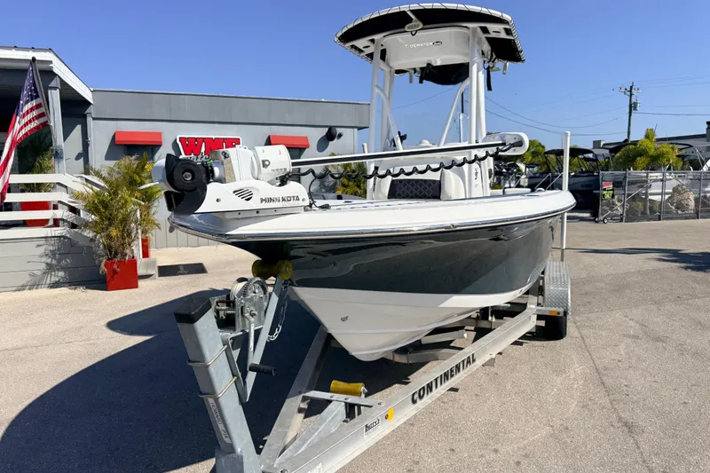 Slide: The Image of 2021 Tidewater 210 LXF boat on trailer outside dealership with American flag. - 4