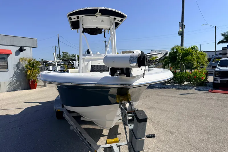Slide: The Image of 2021 Tidewater 210 LXF boat on trailer, parked outdoors under clear sky. - 5