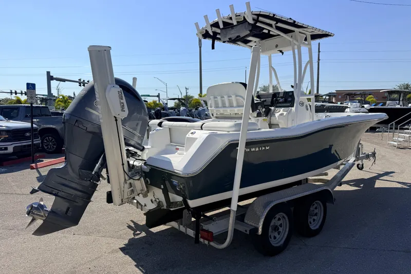 Slide: The Image of 2021 Tidewater 210 LXF boat on trailer, featuring a powerful outboard motor. - 8