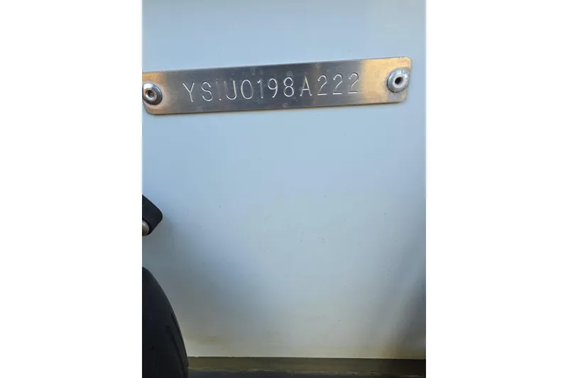 Slide: The Image of 2022 Sailfish 220 WAC boat cockpit with steering wheel and control panel. - 10