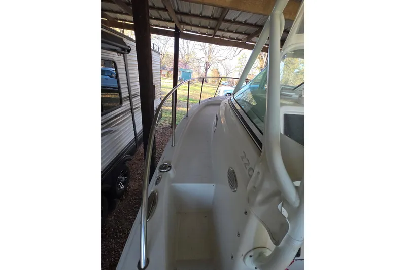Slide: The Image of 2022 Sailfish 220 WAC boat interior with cushioned seating and storage. - 14