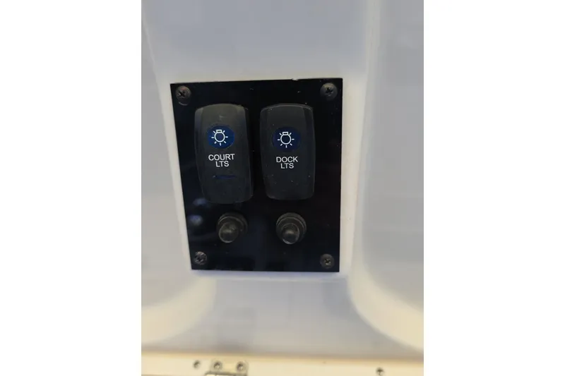 Slide: The Image of Hand operating ProMariner battery status monitor on 2022 Sailfish 220 WAC boat. - 22