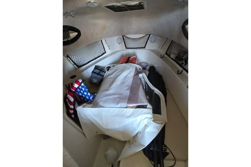 Slide: The Image of Interior of a 2022 Sailfish 220 WAC boat cabin with seating and storage. - 29