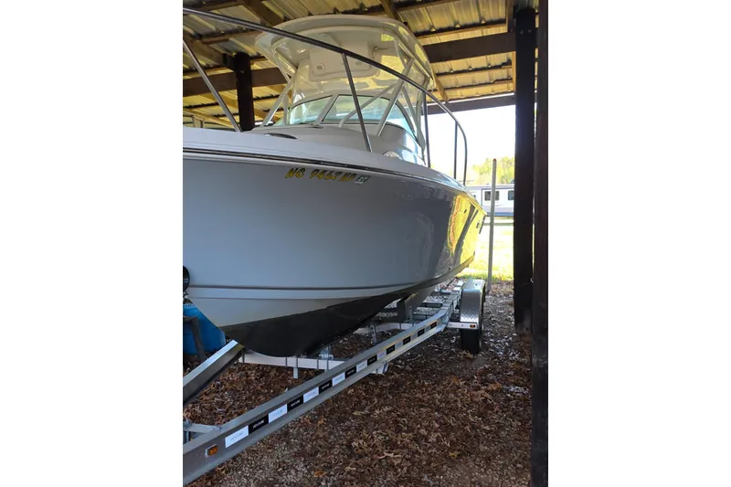 Slide: The Image of 2022 Sailfish 220 WAC boat on trailer, surrounded by autumn leaves. - 3
