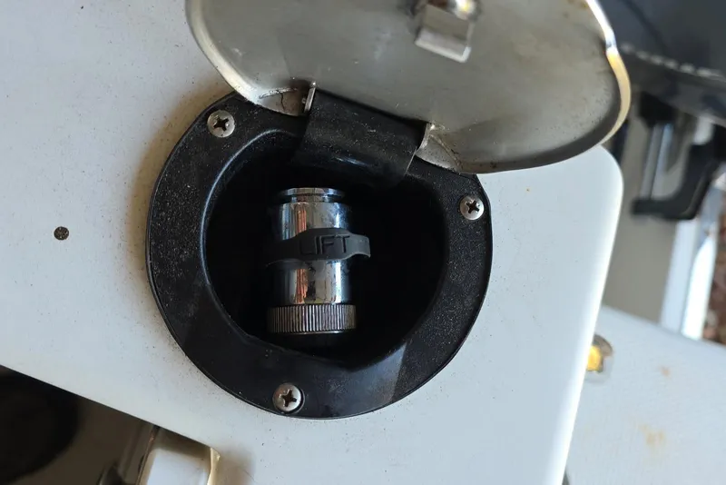 Slide: The Image of 2022 Sailfish 220 WAC boat hull with trim tab and gravel ground. - 30