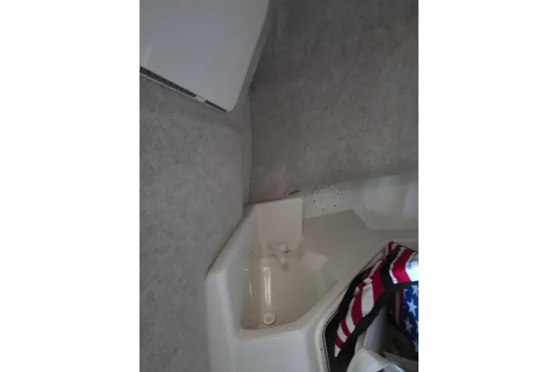 Slide: The Image of 2022 Sailfish 220 WAC boat deck with fishing rod holder and measurement scale. - 34