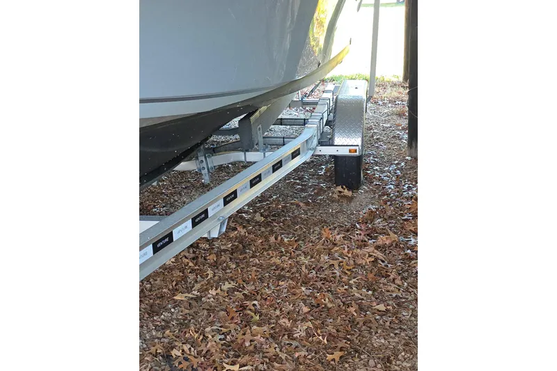 Slide: The Image of 2022 Sailfish 220 WAC boat with Yamaha outboard motor, parked under a shelter. - 5