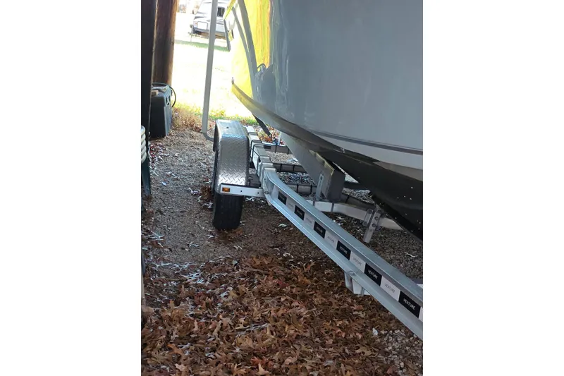 Slide: The Image of 2022 Sailfish 220 WAC boat with Yamaha outboard motor in covered storage. - 6