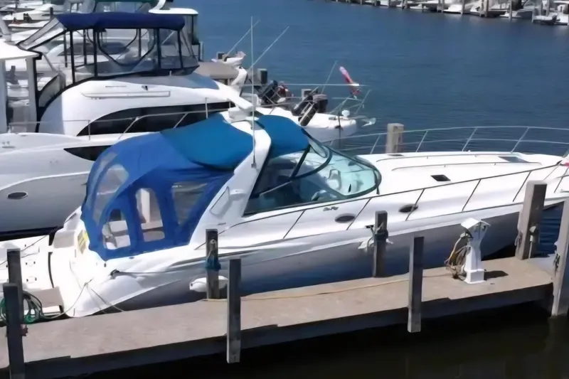 The Image of 2001 Sea Ray Sundancer 400 yacht docked at marina with blue canopy. - 1
