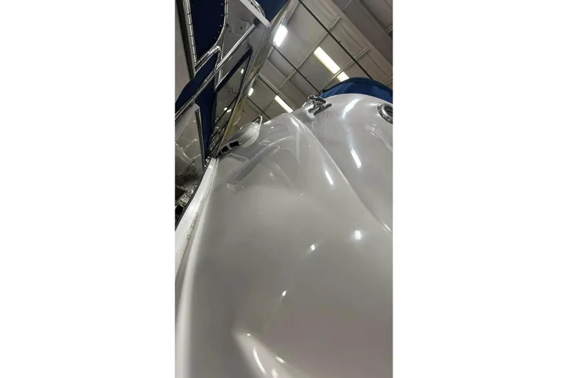 Slide: The Image of 2001 Sea Ray Sundancer 400 yacht in indoor storage, showcasing sleek white hull design. - 10