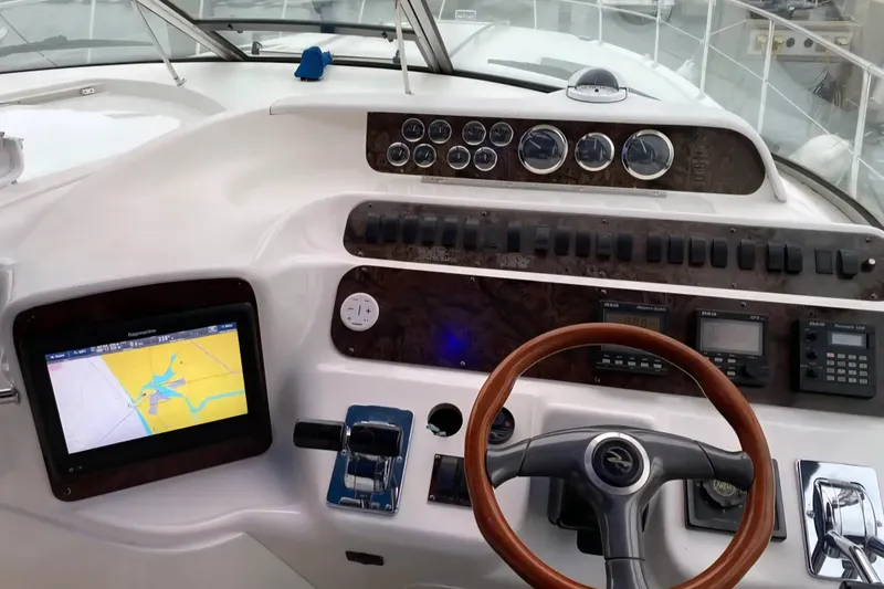 Slide: The Image of Cockpit of 2001 Sea Ray Sundancer 400 with navigation system and wooden steering wheel. - 13