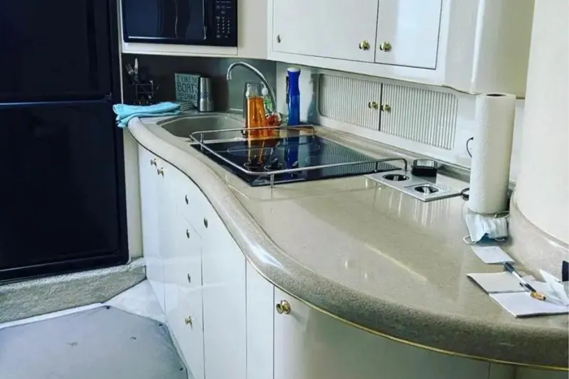 Slide: The Image of Luxurious kitchen interior of 2001 Sea Ray Sundancer 400 yacht with modern amenities. - 16