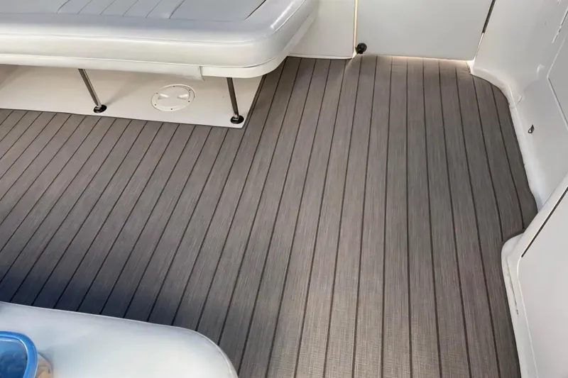 Slide: The Image of Deck of 2001 Sea Ray Sundancer 400 with gray flooring and white seating. - 17