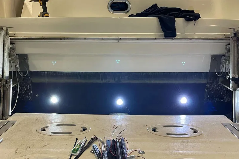 Slide: The Image of 2001 Sea Ray Sundancer 400 swim platform with underwater lights and maintenance tools. - 5