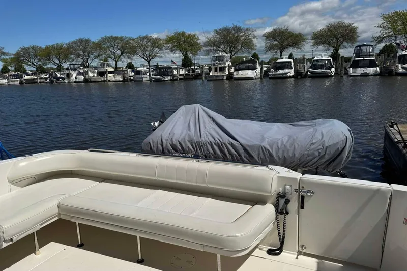 Slide: The Image of 2001 Sea Ray Sundancer 400 yacht docked at marina with covered boat nearby. - 6