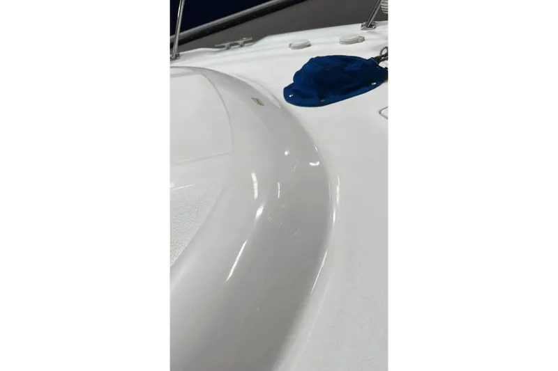 Slide: The Image of 2001 Sea Ray Sundancer 400 deck with blue cover and sleek white surface. - 8