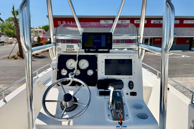 Slide: The Image of Console of a 2001 Sea Fox 215 Bay Fisher boat with steering wheel and gauges. - 13