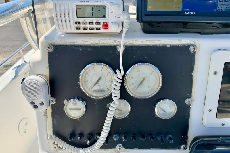 Slide: The Image of Control panel of a 2001 Sea Fox 215 Bay Fisher boat with gauges and communication devices. - 16