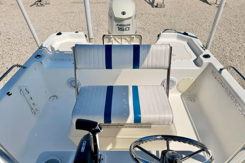 Slide: The Image of 2001 Sea Fox 215 Bay Fisher boat interior with seating and steering wheel. - 18