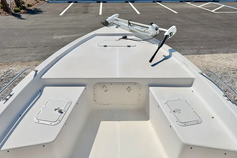 Slide: The Image of 2001 Sea Fox 215 Bay Fisher boat deck with storage compartments and trolling motor. - 23