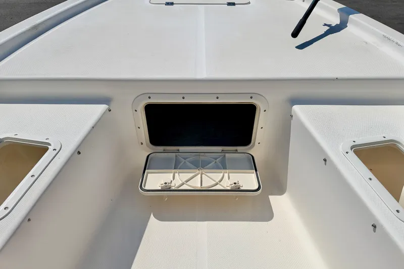 Slide: The Image of 2001 Sea Fox 215 Bay Fisher boat deck with open storage compartments. - 26