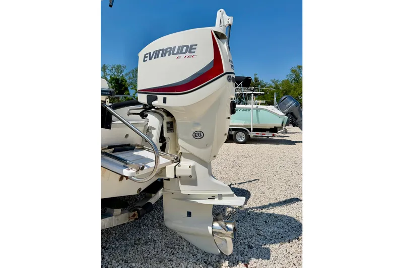 Slide: The Image of Outboard motor on a 2001 Sea Fox 215 Bay Fisher boat, parked on gravel. - 29