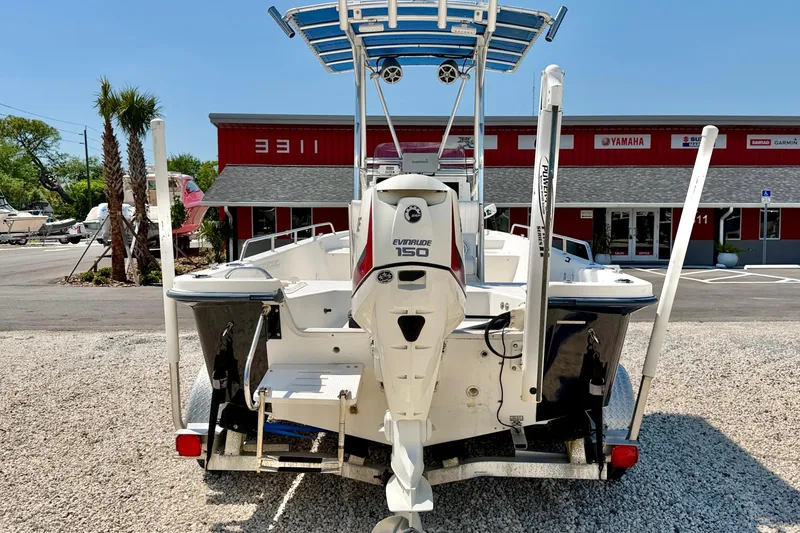 Slide: The Image of 2001 Sea Fox 215 Bay Fisher boat with Evinrude 150 engine, parked outdoors. - 6
